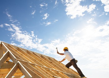 Man in construction hat working on the frame what will be a home built by Home Builders in Peoria IL